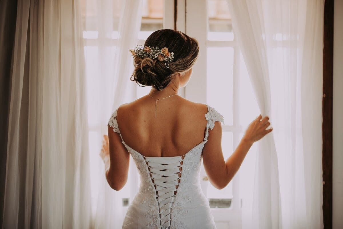 Woman with an elegant natural-looking tan dressed for a wedding